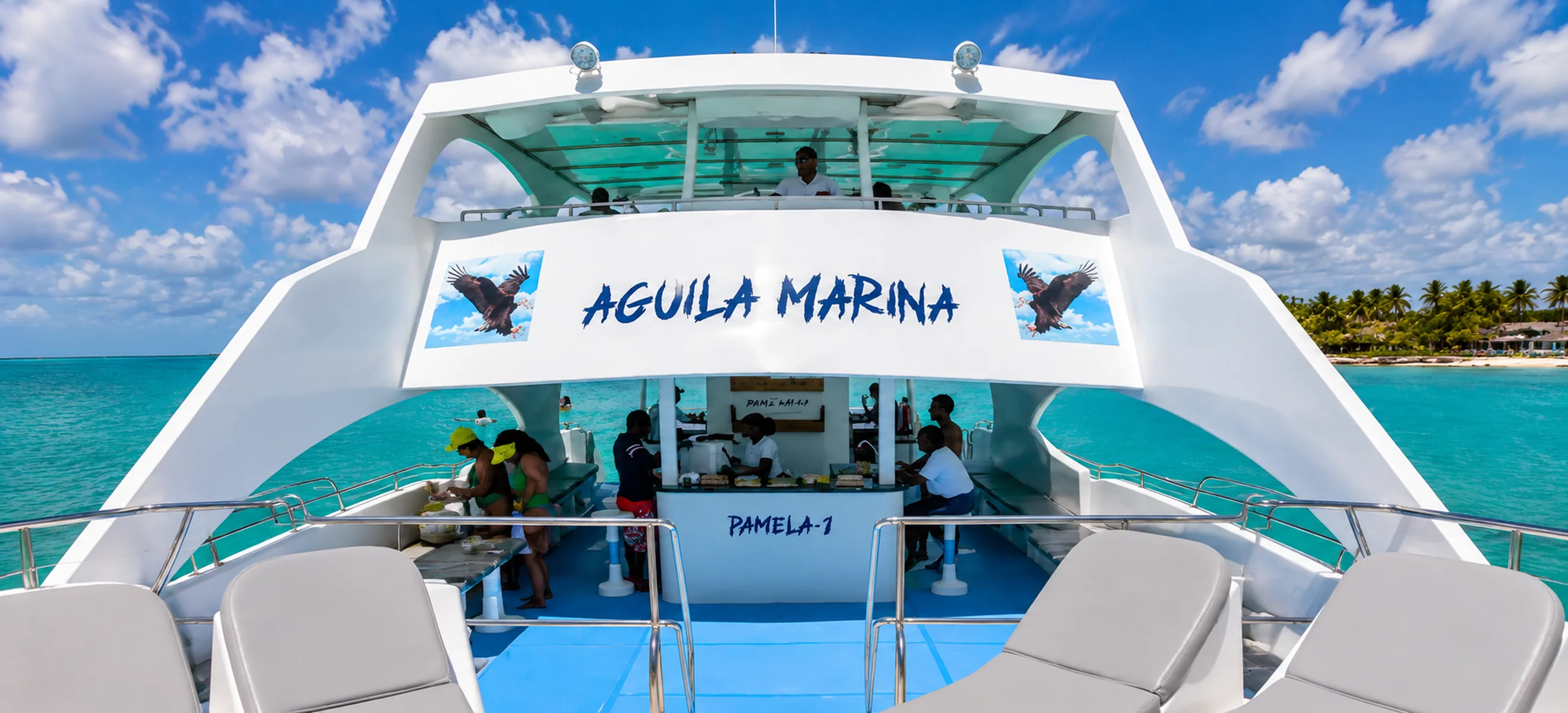 Upper deck of the Aguila Marina luxury private yacht cruising the turquoise waters of Punta Cana, Dominican Republic, featuring spacious seating and panoramic Caribbean ocean views. 