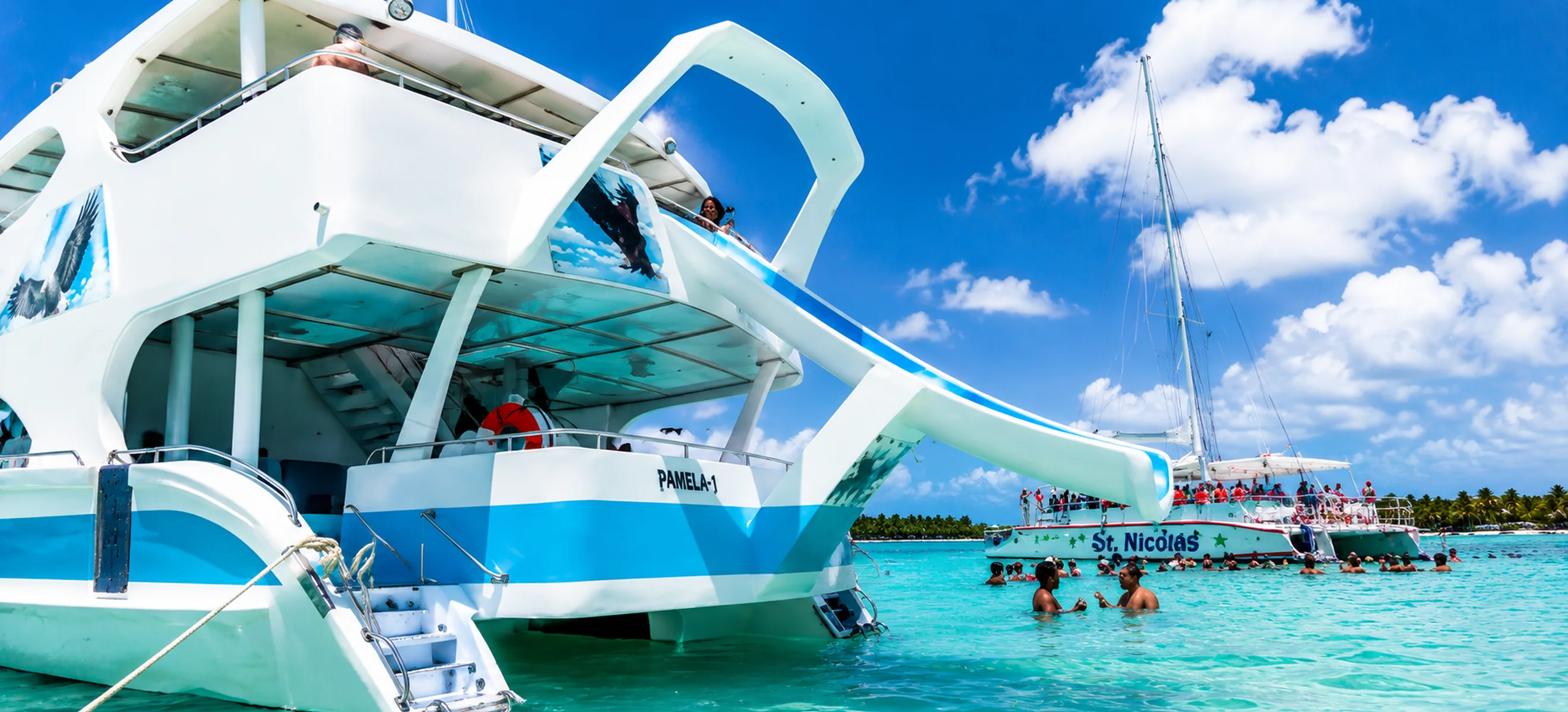 Luxury Aguila Marina yacht with a waterslide anchored in the crystal-clear Caribbean waters of Punta Cana, Dominican Republic, during a private yacht charter excursion. 