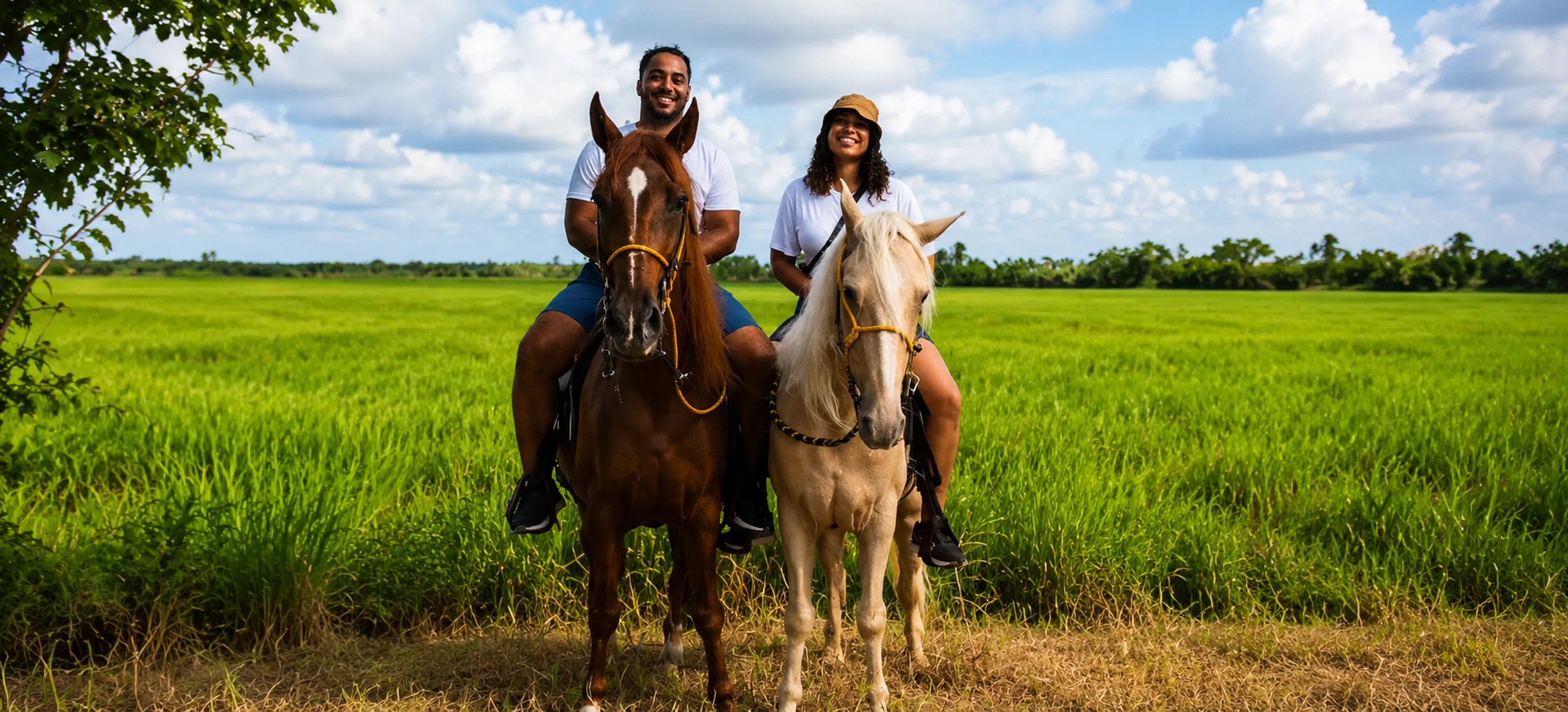 Couple riding horses through the scenic Dominican countryside during a guided horseback riding excursion in Punta Cana.