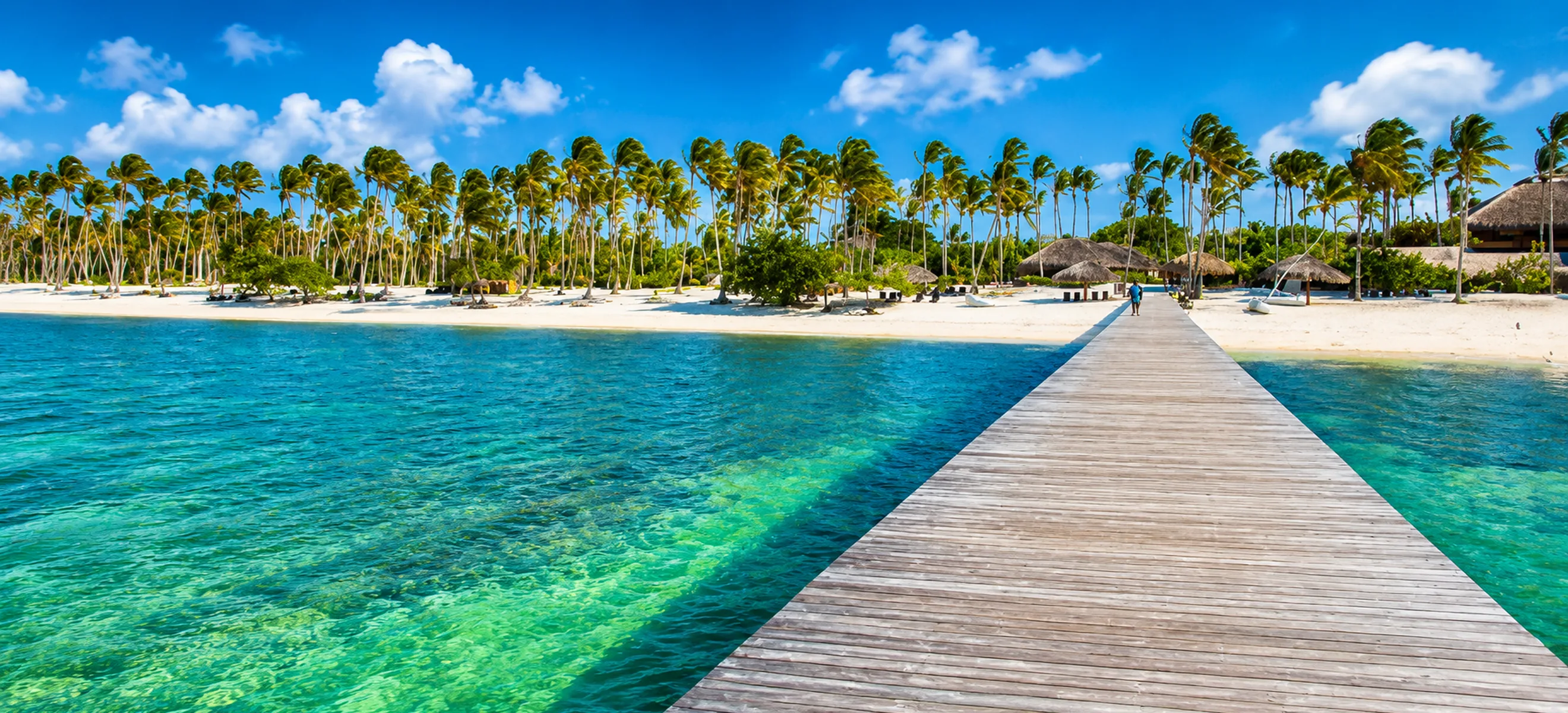 	Wooden pier leading to a tropical beach and dolphin park in Punta Cana, Dominican Republic.