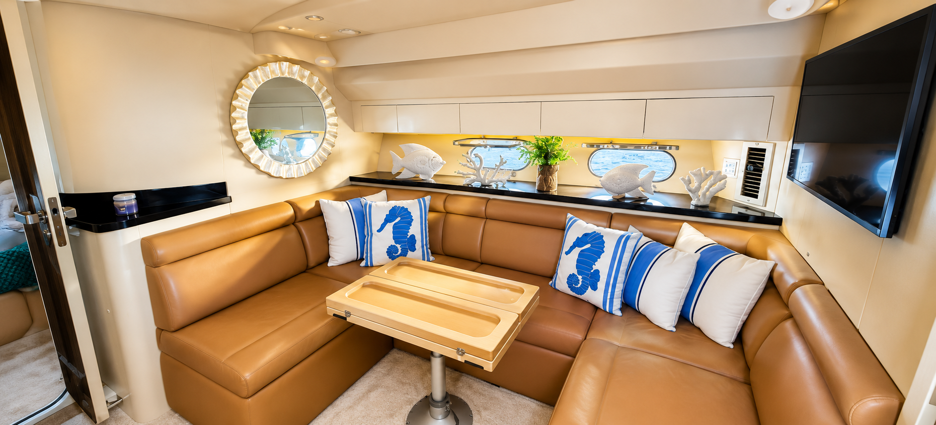 Luxury yacht salon lounge in Punta Cana featuring premium leather seating, elegant nautical décor, panoramic windows, and a spacious living area aboard a private yacht charter