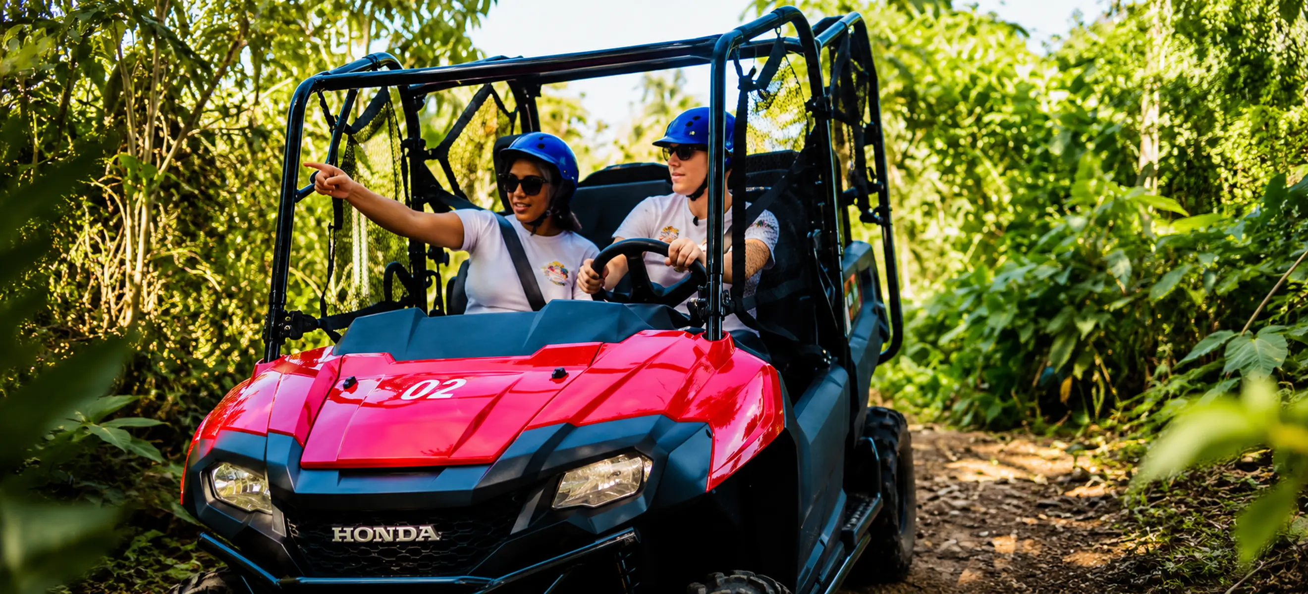 Guests driving a guided 4x4 Honda jungle buggy through lush tropical forest trails during the Monkeyland & Jungle Buggies Punta Cana adventure in the Dominican Republic.