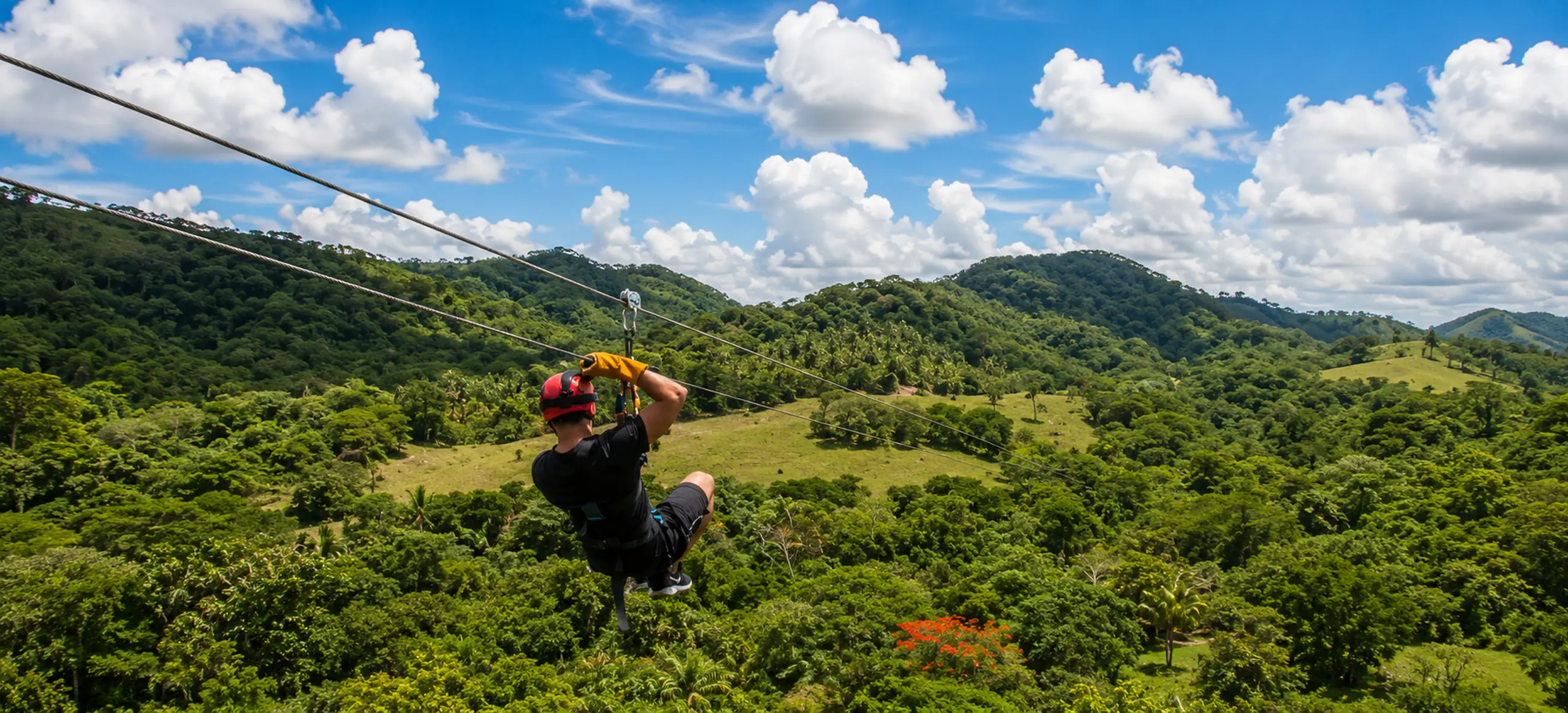 Guest soaring above the Dominican rainforest on a thrilling zipline during the Monkeyland & Zipline Adventure Punta Cana, offering breathtaking tropical views and one of the top eco adventures in the Dominican Republic.