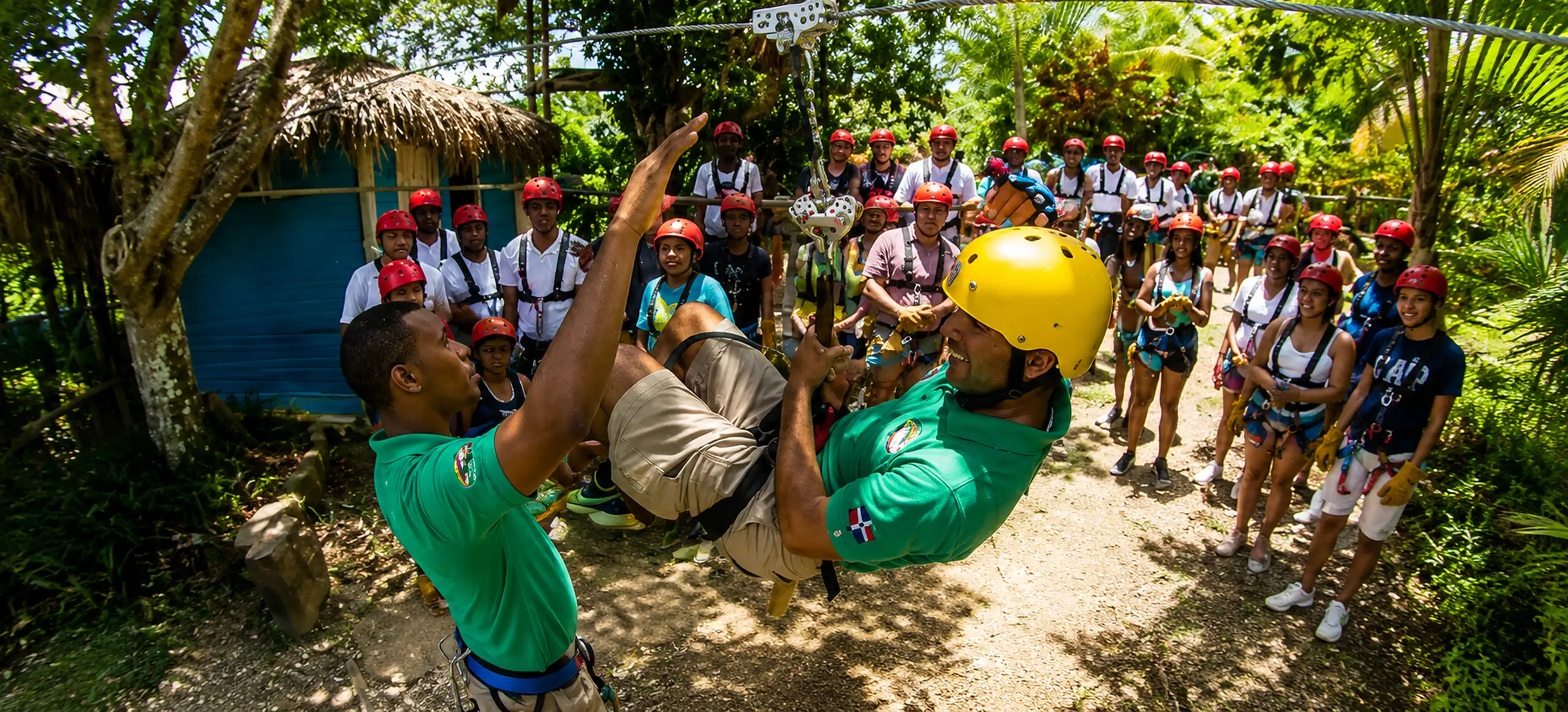 Professional zipline guide assisting a guest during the safety briefing before the Monkeyland & Zipline Adventure Punta Cana, one of the Dominican Republic