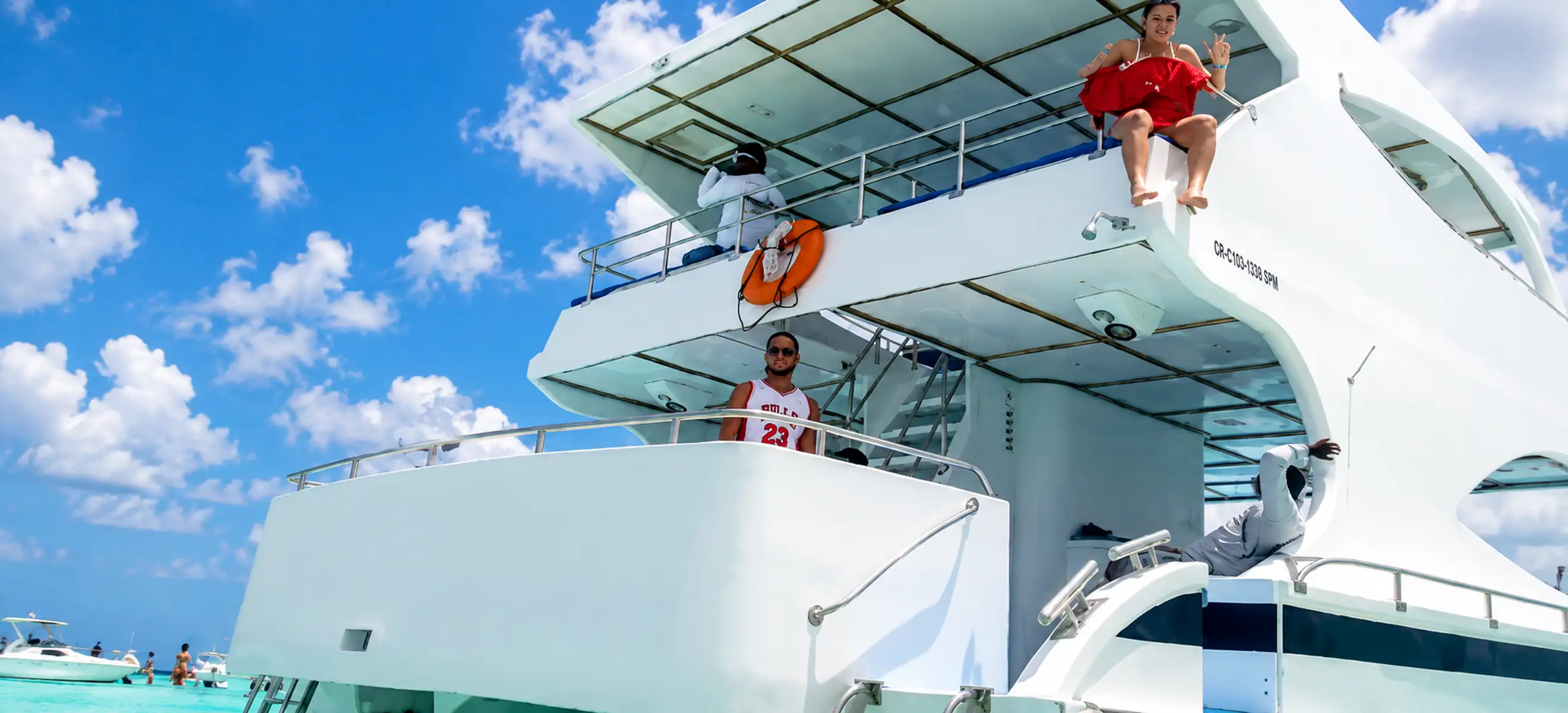 Luxury catamaran anchored near Saona Island with guests enjoying a sunny day during a Punta Cana yacht excursion in the Dominican Republic.