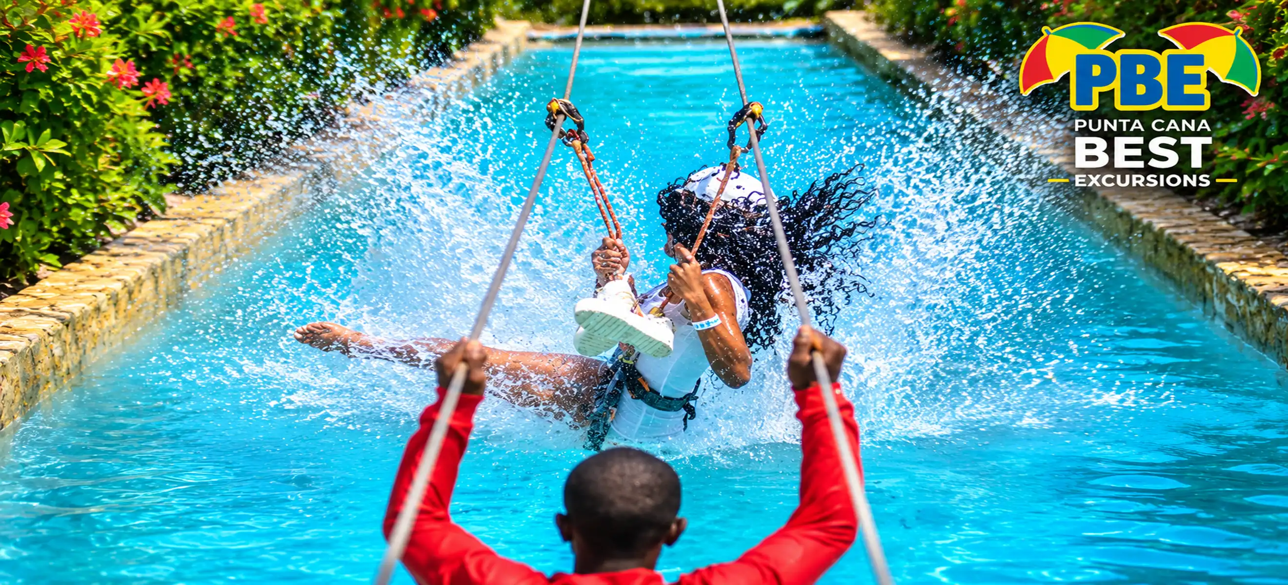 Guest enjoying a thrilling water swing adventure with a splash landing during a Punta Cana excursion in the Dominican Republic.
