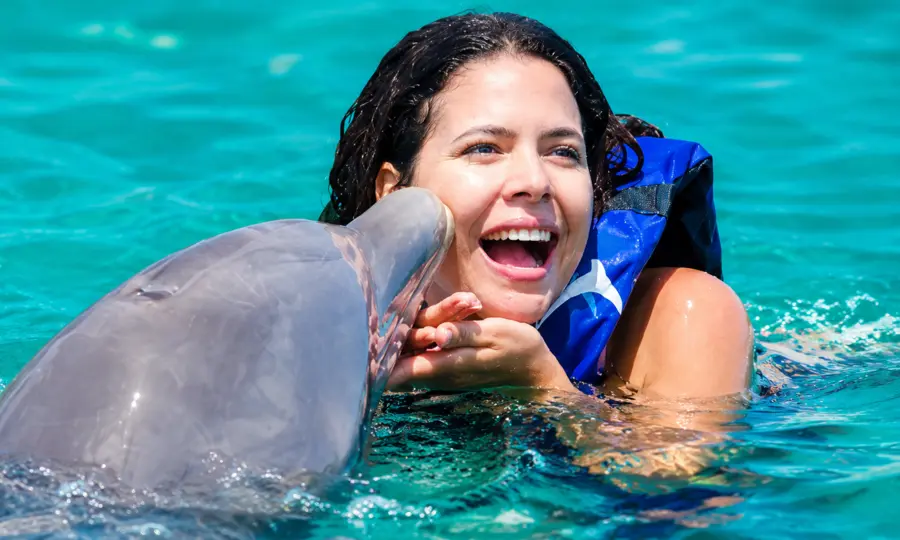 Guest receiving a dolphin kiss during a Punta Cana dolphin encounter