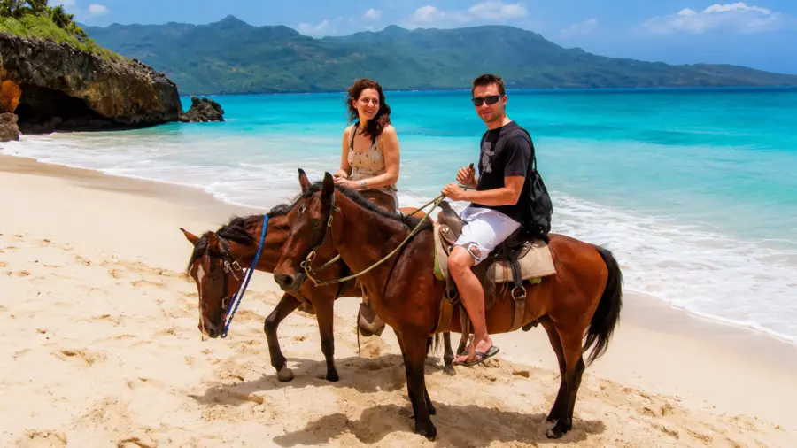 Horseback riders traveling along a scenic tropical beach in Punta Cana