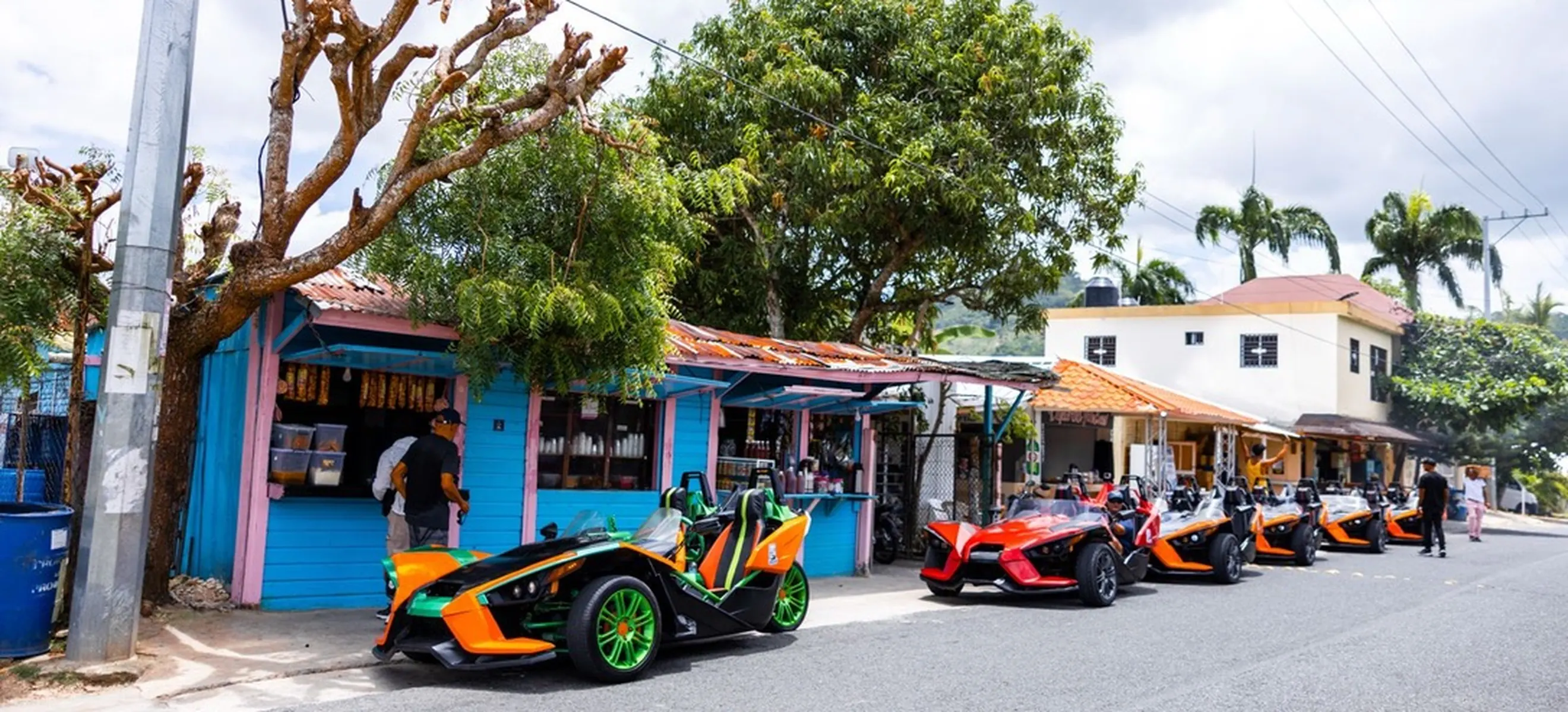 Colorful Polaris Slingshot convoy visiting a local Dominican village near Nisibón