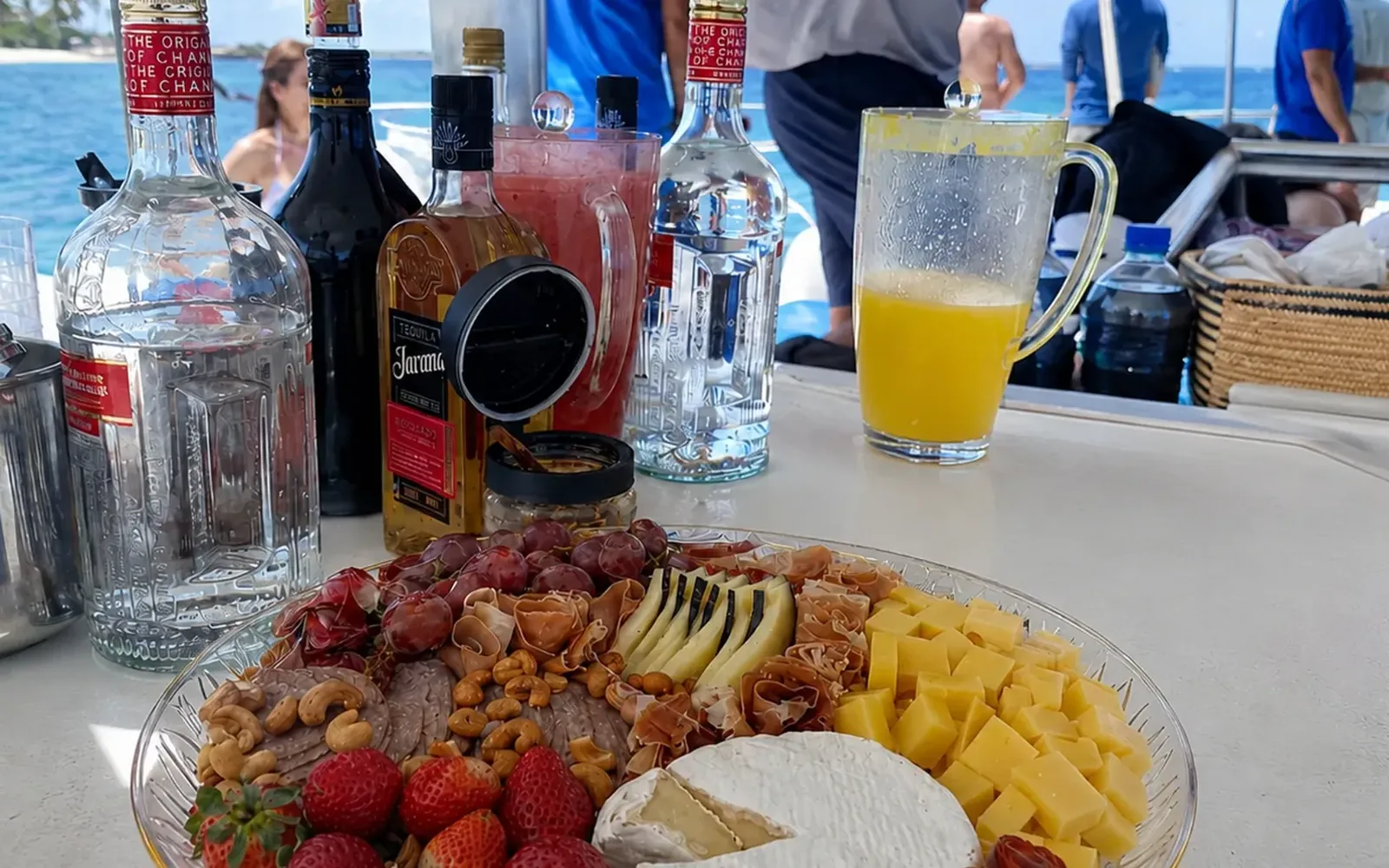 Charcuterie platter and tropical beverages aboard a private Saona Island catamaran